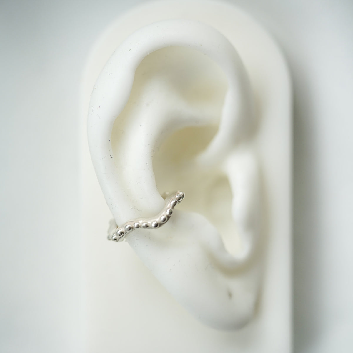 ACFJ Wavy silver ear cuff with beads on a ear