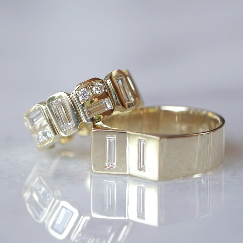 two wedding bans in yellow gold with baguette diamonds