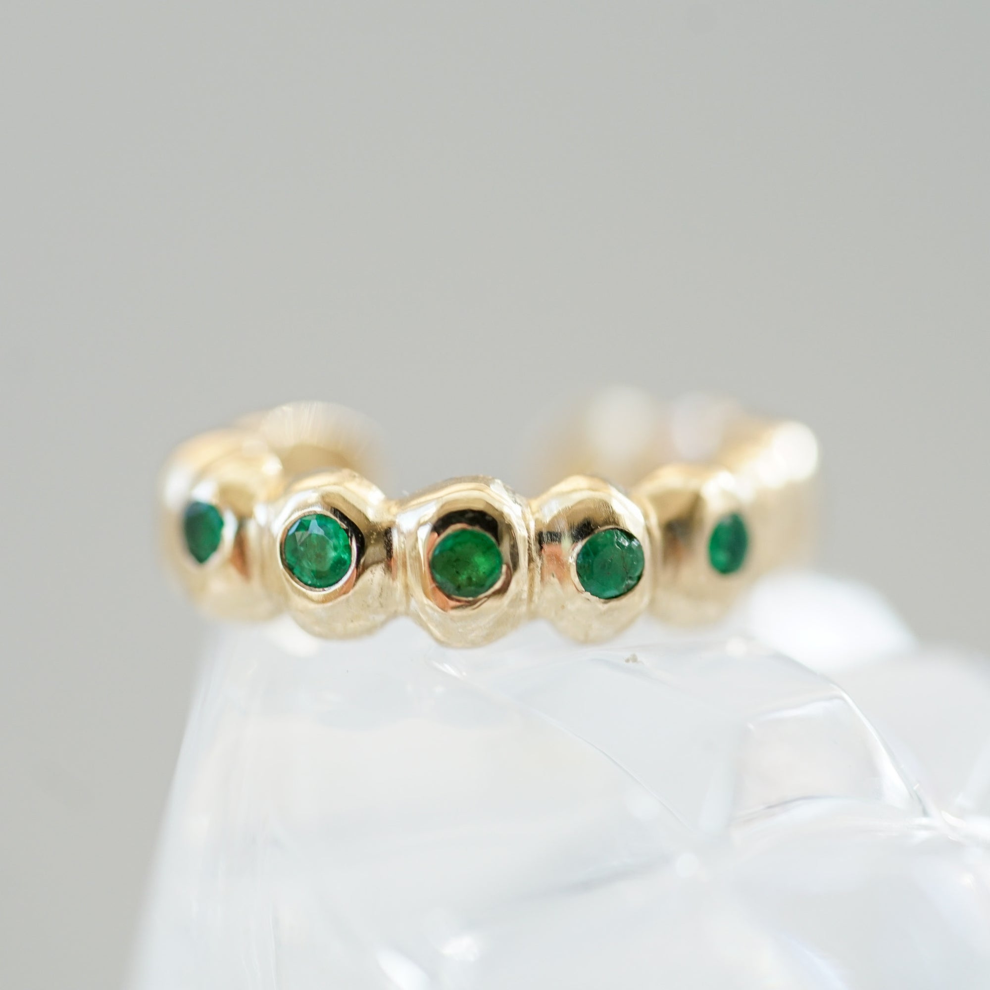 gold ear cuff with emeralds